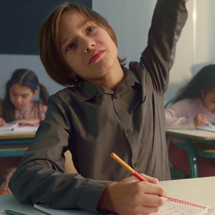 intellectually curious student raising hand ask what is that