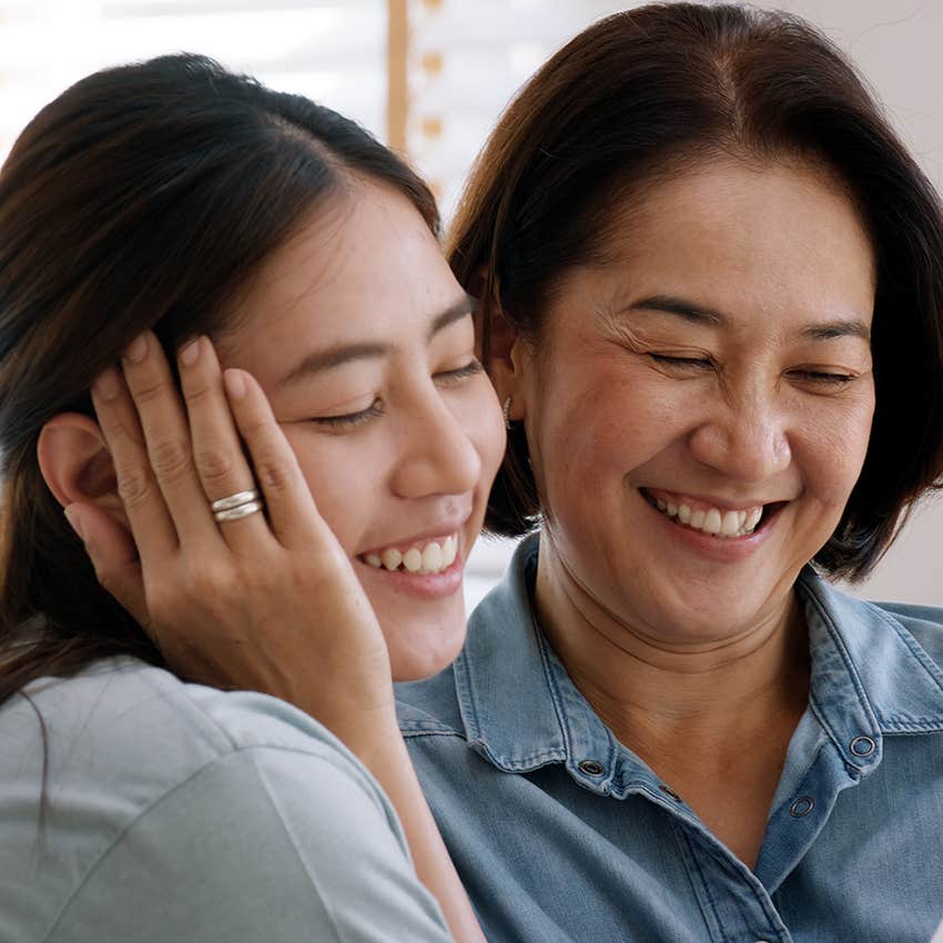 loving mom hugging her adult daughter