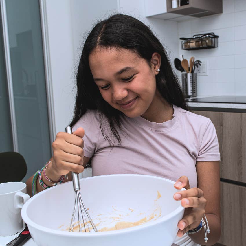 kid cooking for the family mixing in a bowl