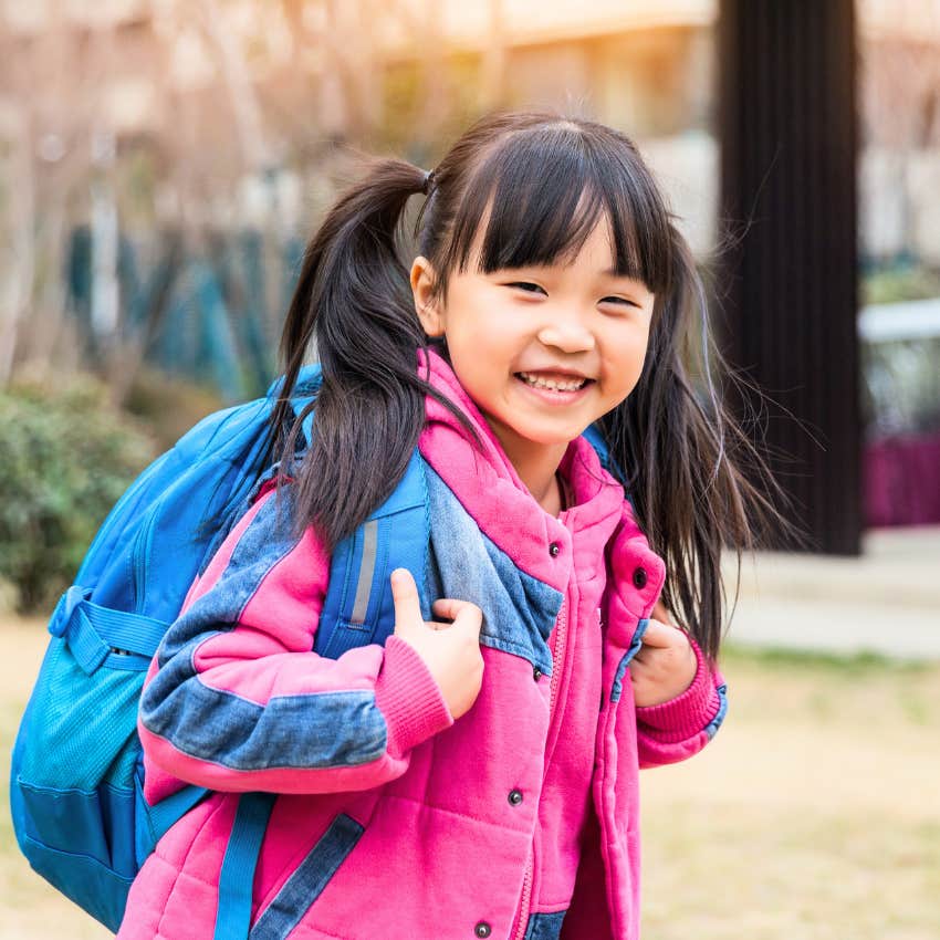 little girl walking to school without a parent's help