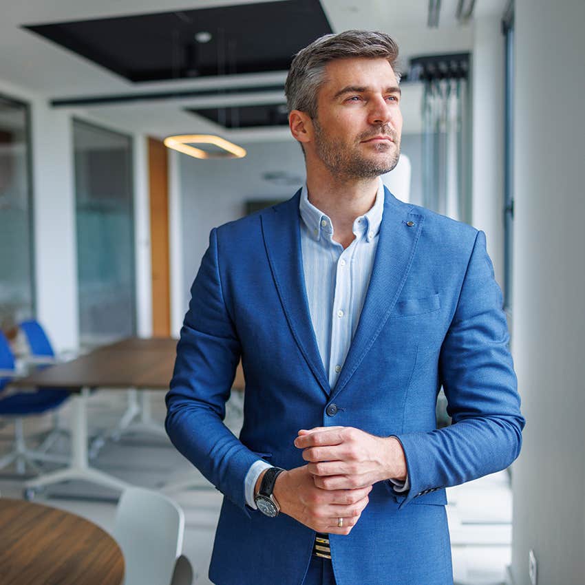 older professional man looking around his workplace