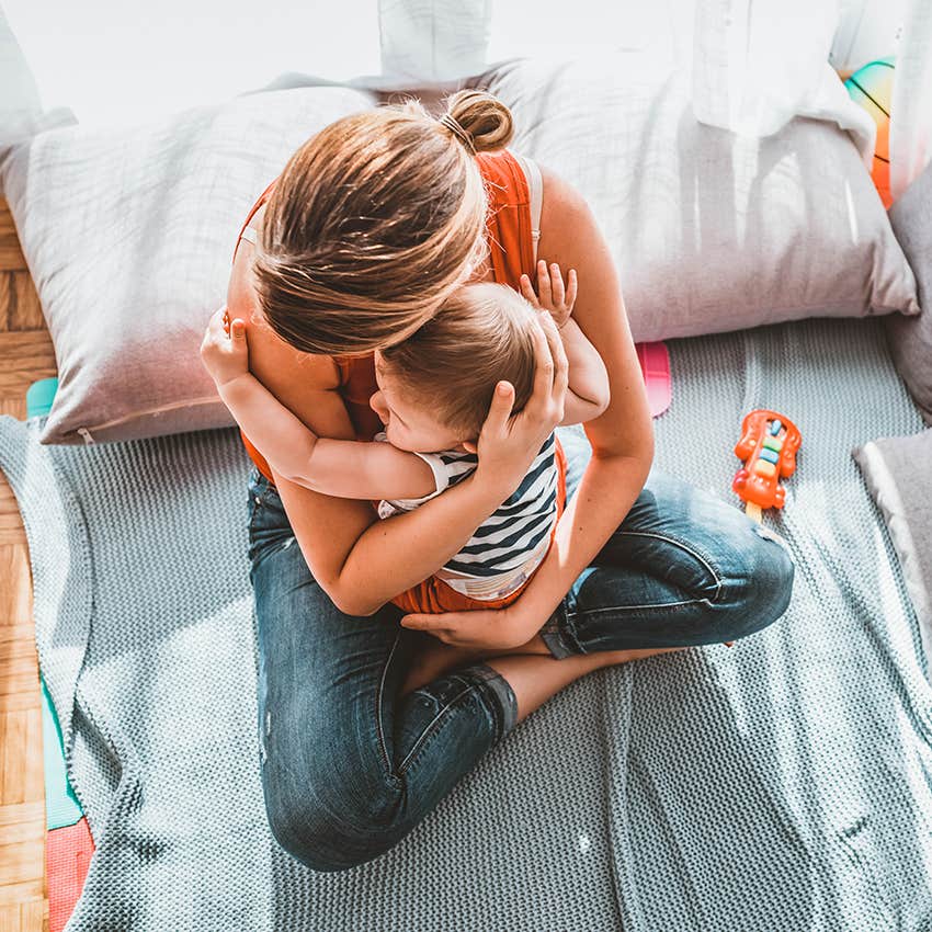 stay at home mom holding baby at home