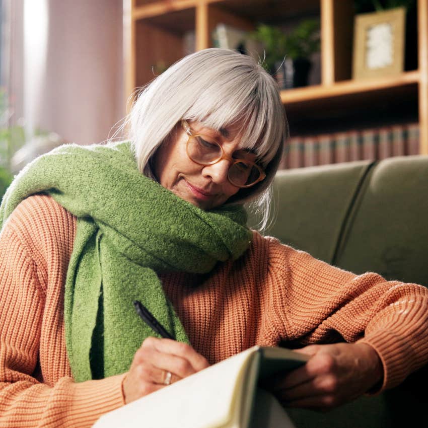 woman raised without a smartphone writing in cursive