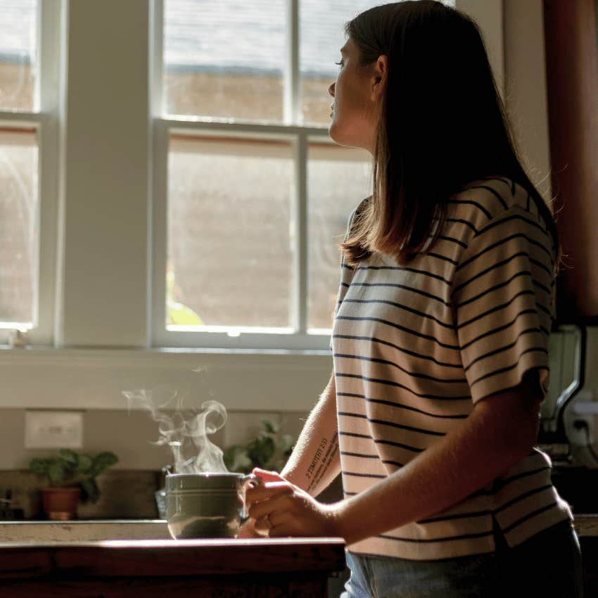 lonely woman looking out of window