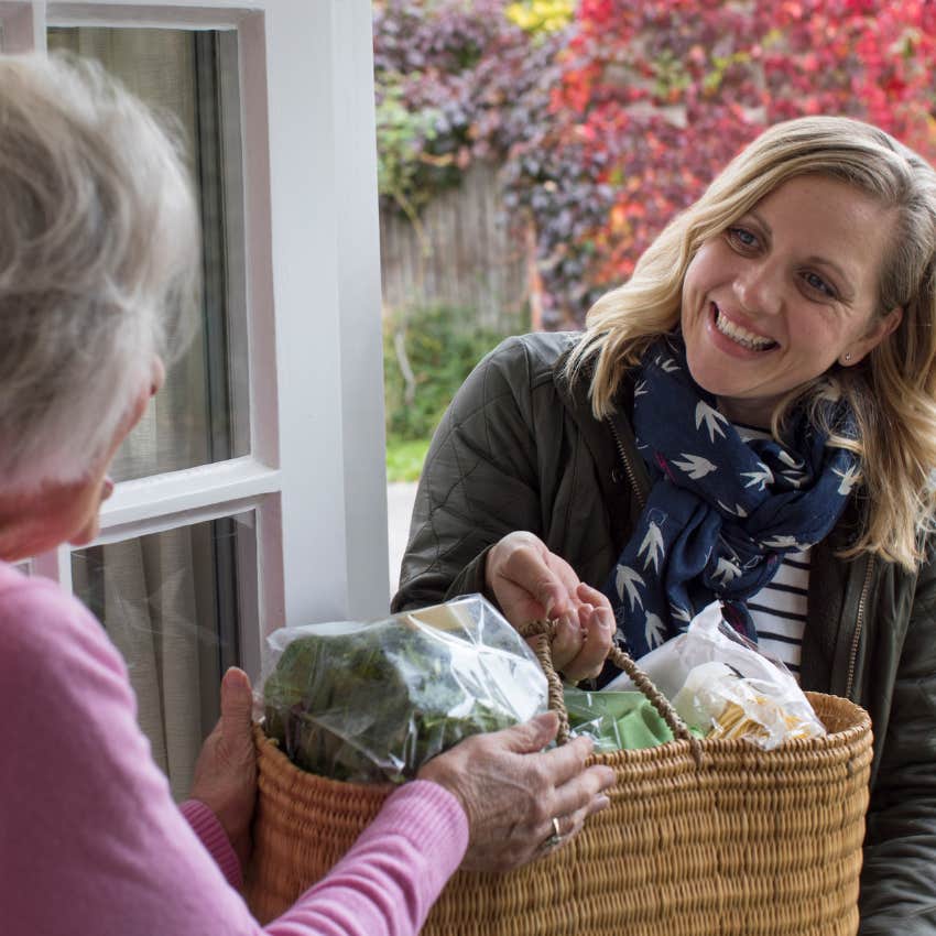 generous lower class woman bringing groceries to help her neighbor