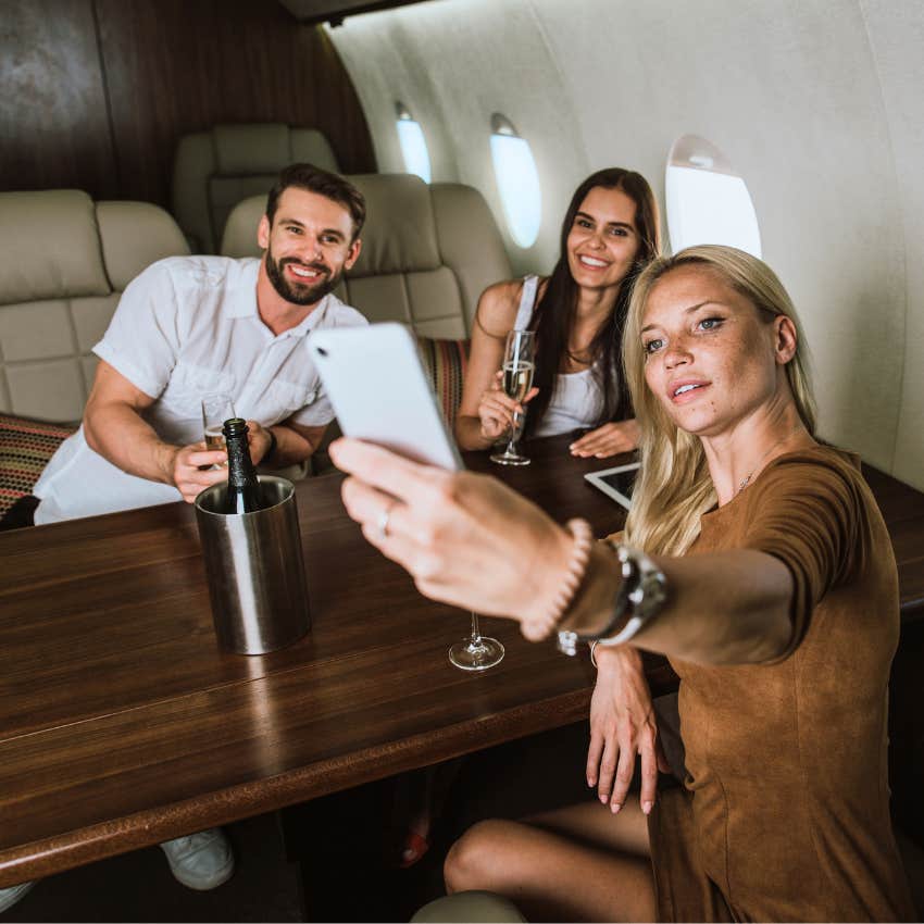 wealthy group of friends taking a selfie on a private jet