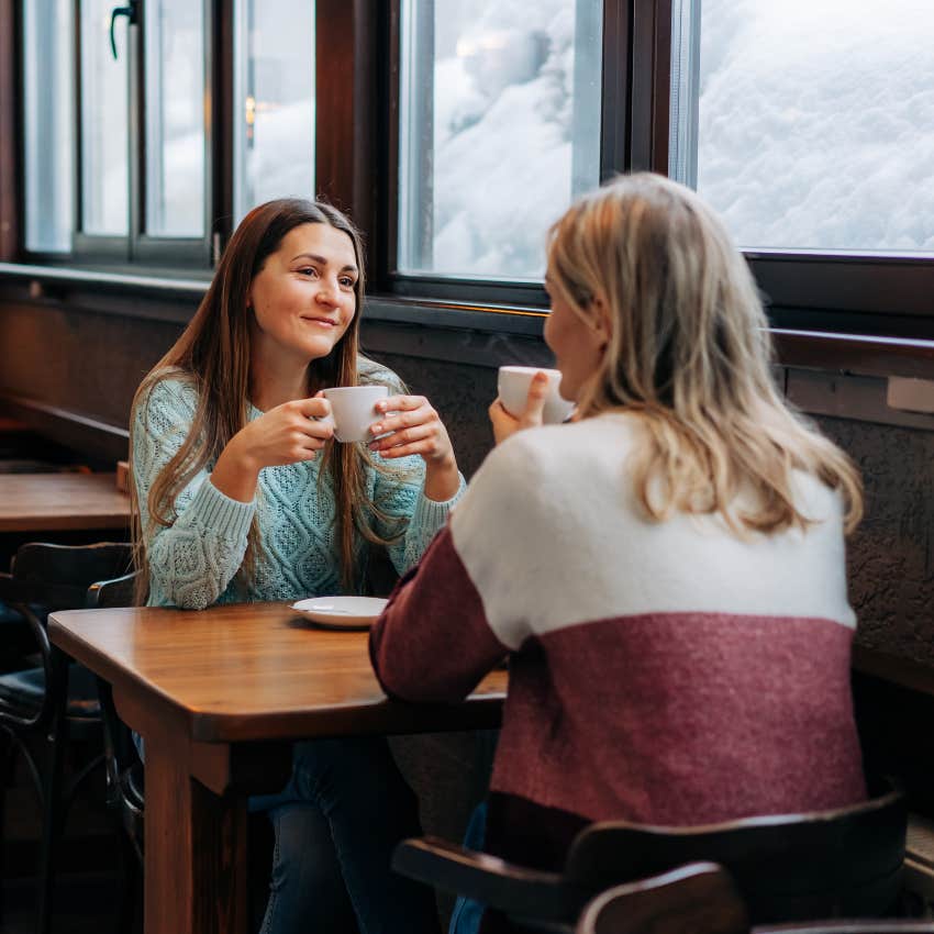 two friends drinking coffee at a cozy cafe