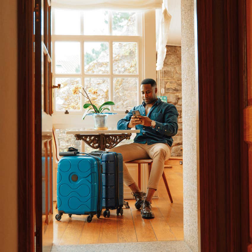 man moving his suitcases into an apartment so she can foot the bill 