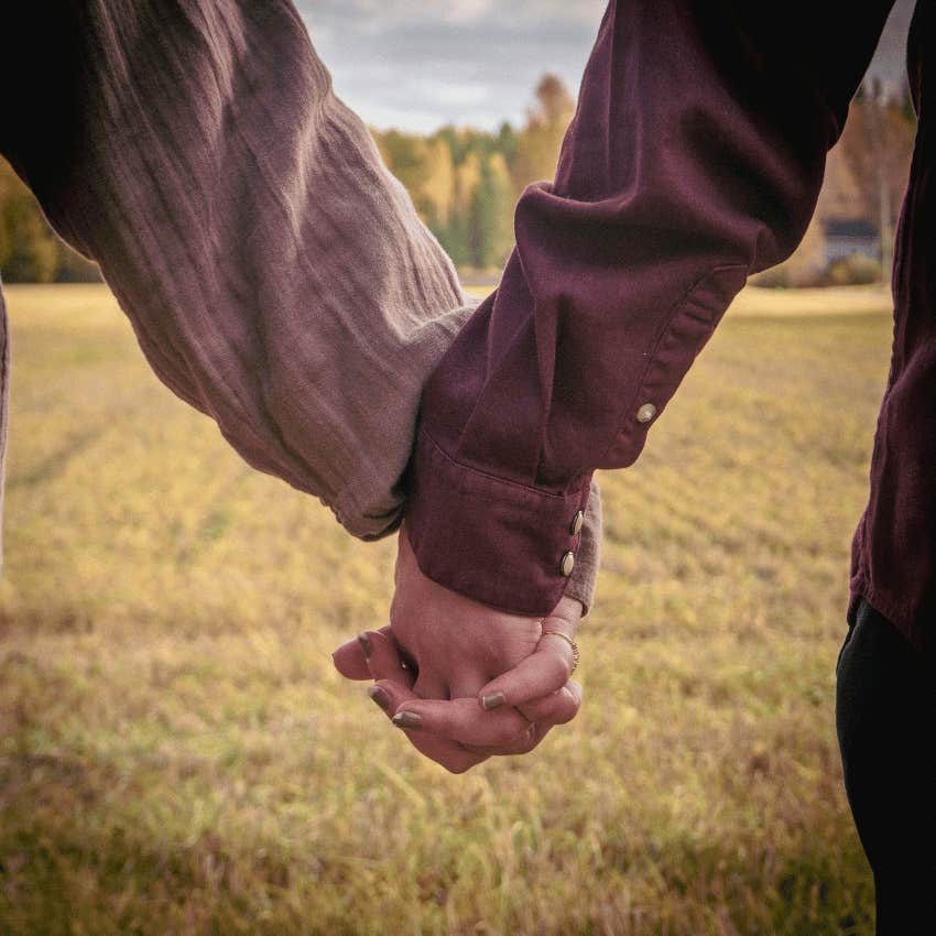 man and woman holding hands which is a good sign he is into her 