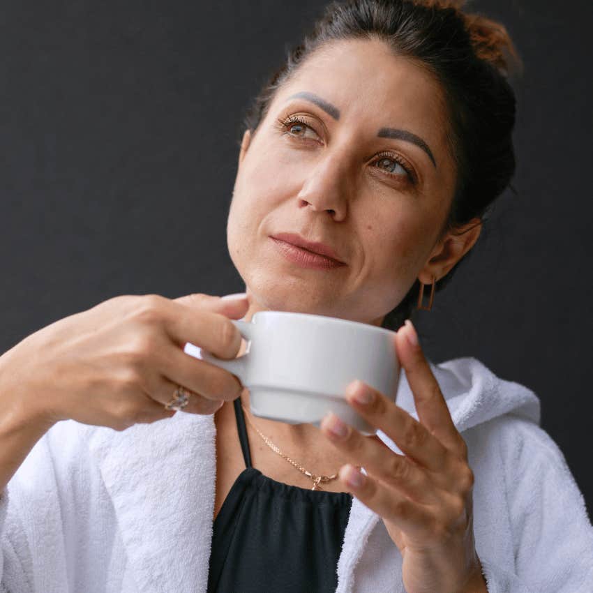 mature woman treating herself like royalty and drinking tea
