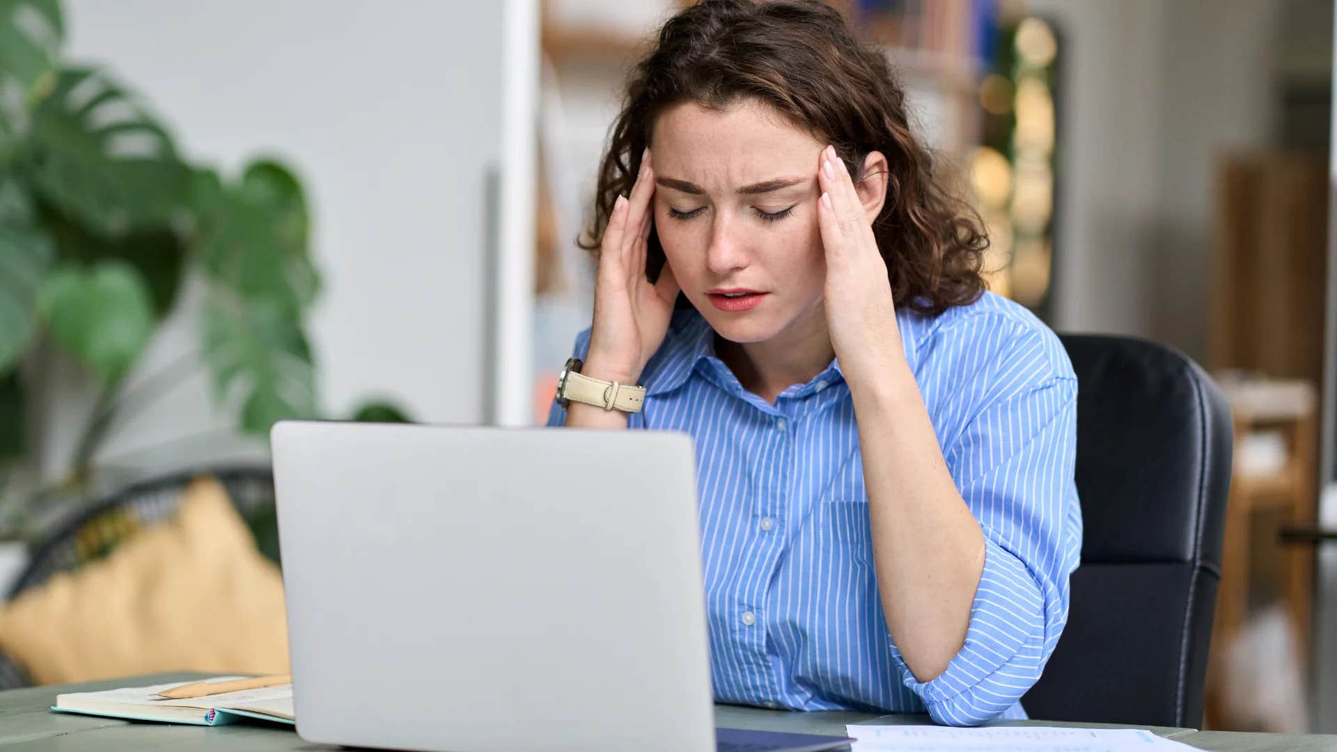 stressed out millennial employee sitting at desk