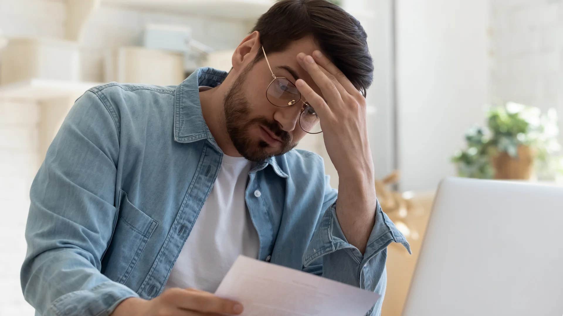underpaid millennial man feeling stressed at work