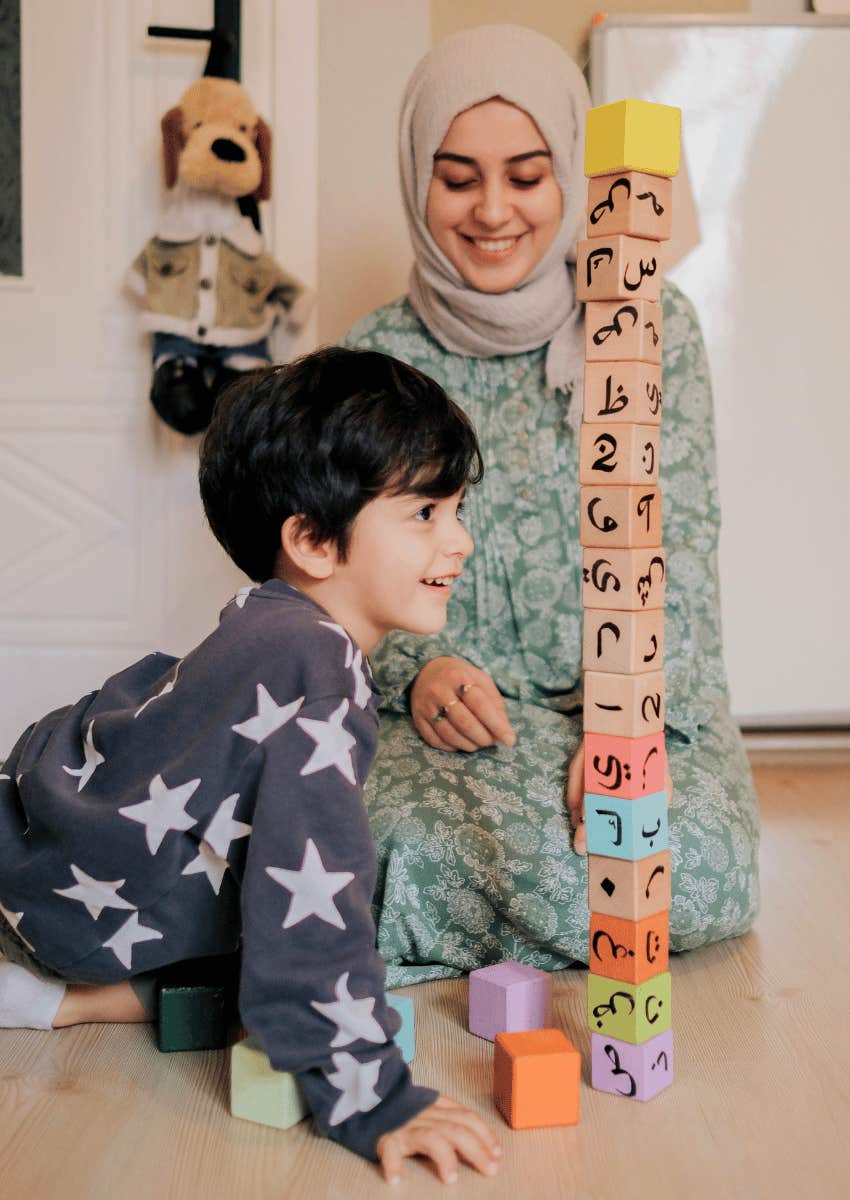mom and son playing with toy blocks