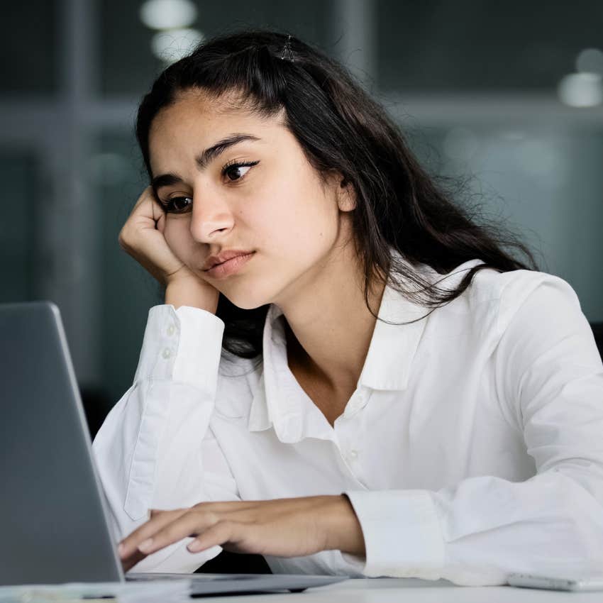 young woman looking stressed at work thinking about her future