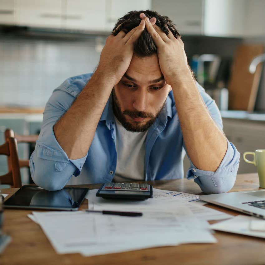 man looking over his finances finding it too risky to leave his career