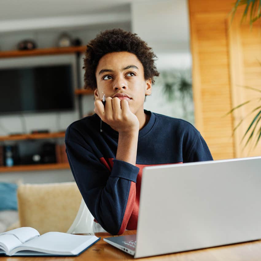 Teenager who knows that school ends after graduation sitting with a computer.