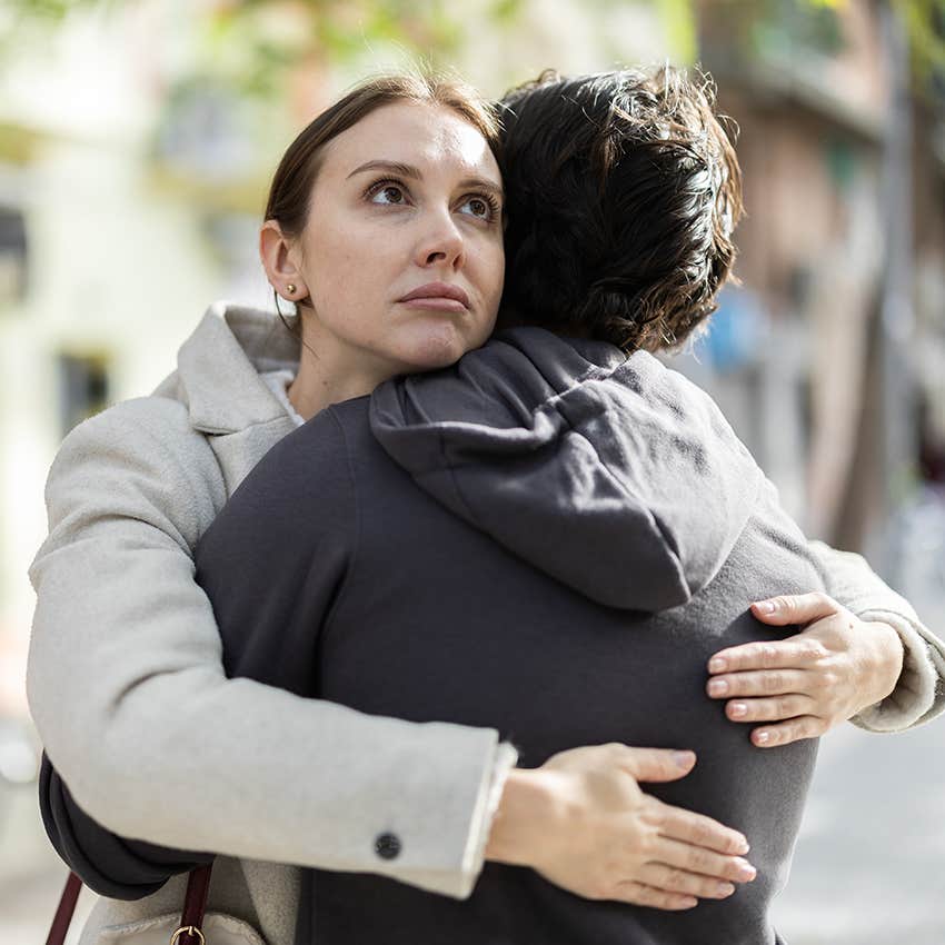 annoyed woman hugging upset man 