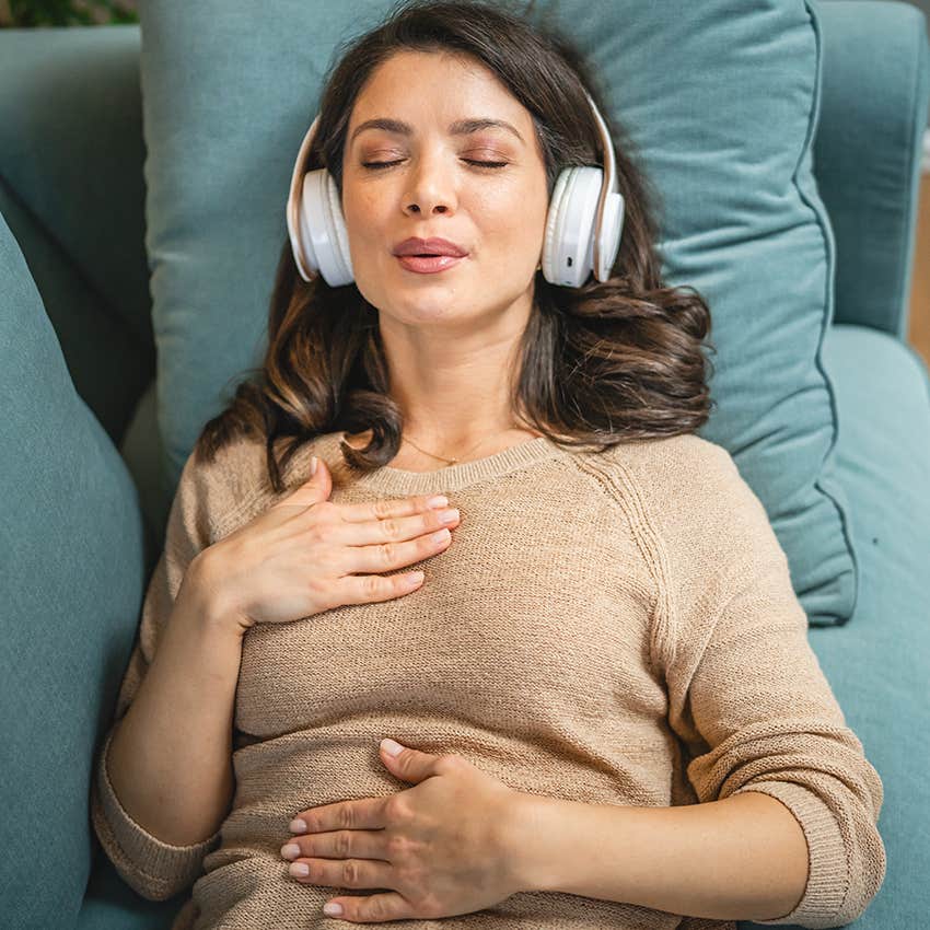 woman practicing meditation with headphones on
