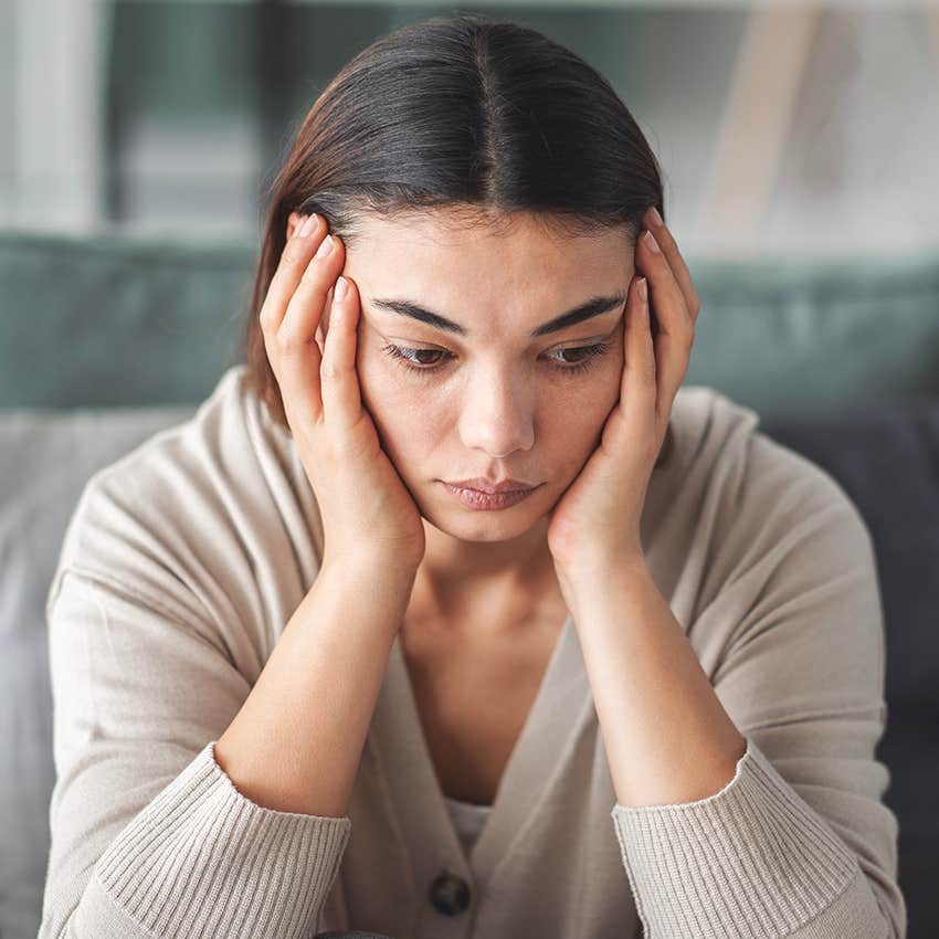 depressed woman with head in hands exhausted by hobbies she once loved