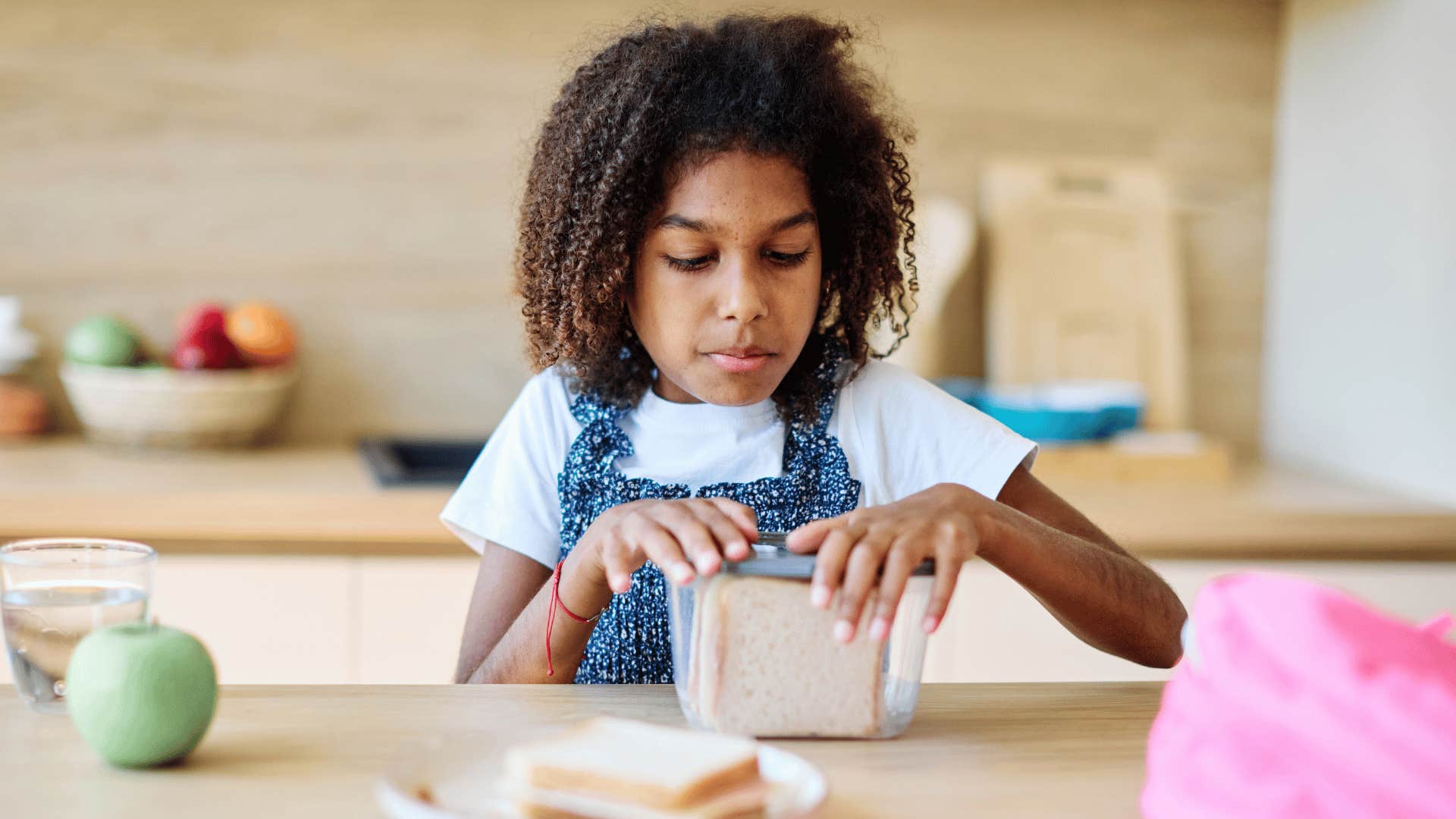 little girl cooking family meals by herself