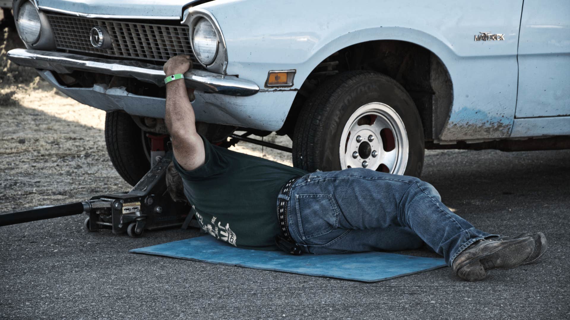 man in black shirt working on cars