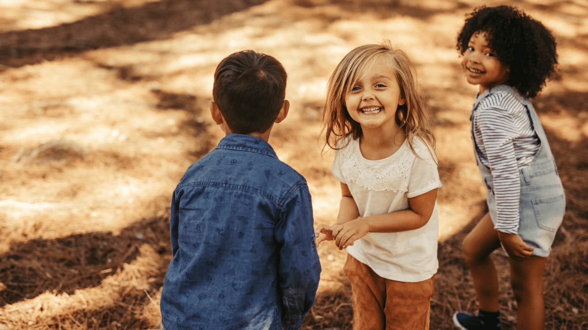 group of kids playing outside in dirty clothes