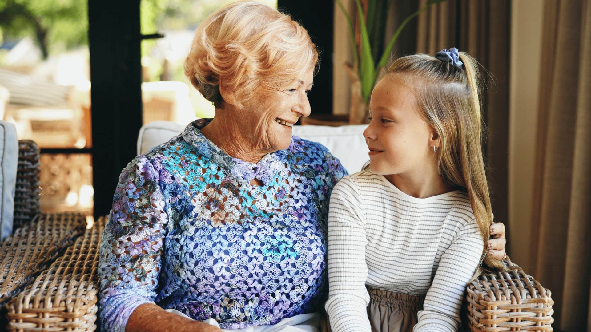little girl respecting her elders sitting with grandmother