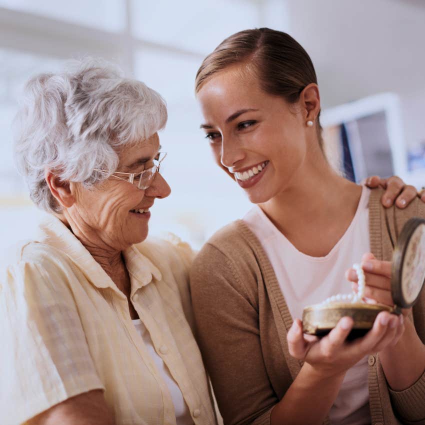 Woman holding onto traditions and family heirlooms at home.