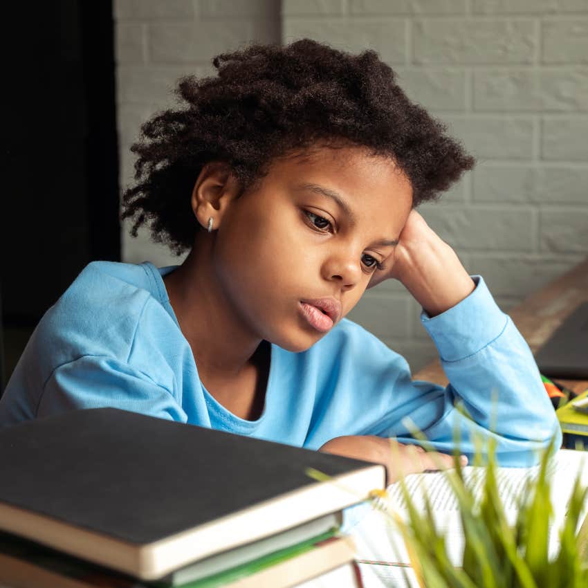 sad little boy thinking while parents made him feel guilty