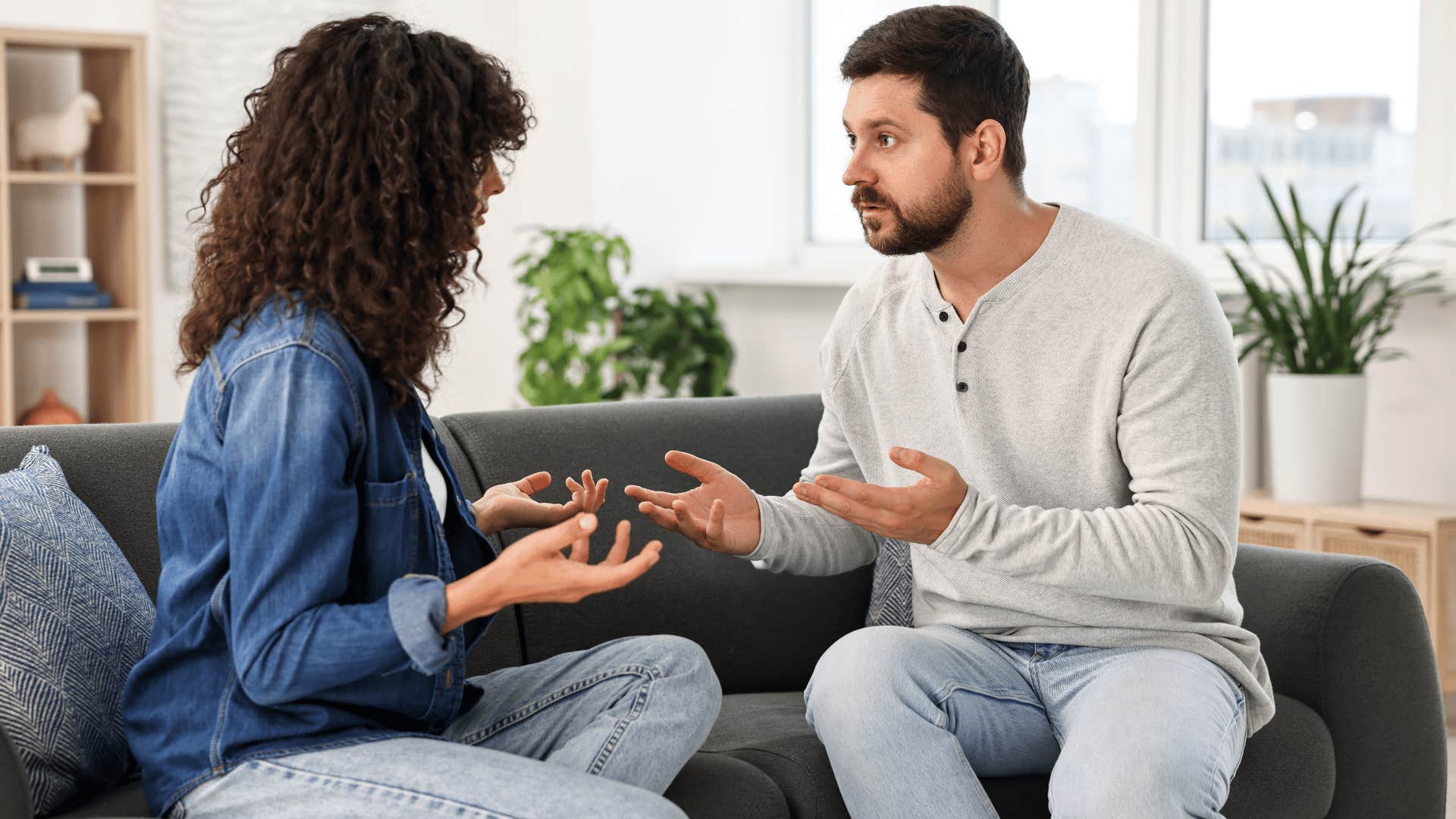 couple arguing on the couch as man tells woman that's just how i am