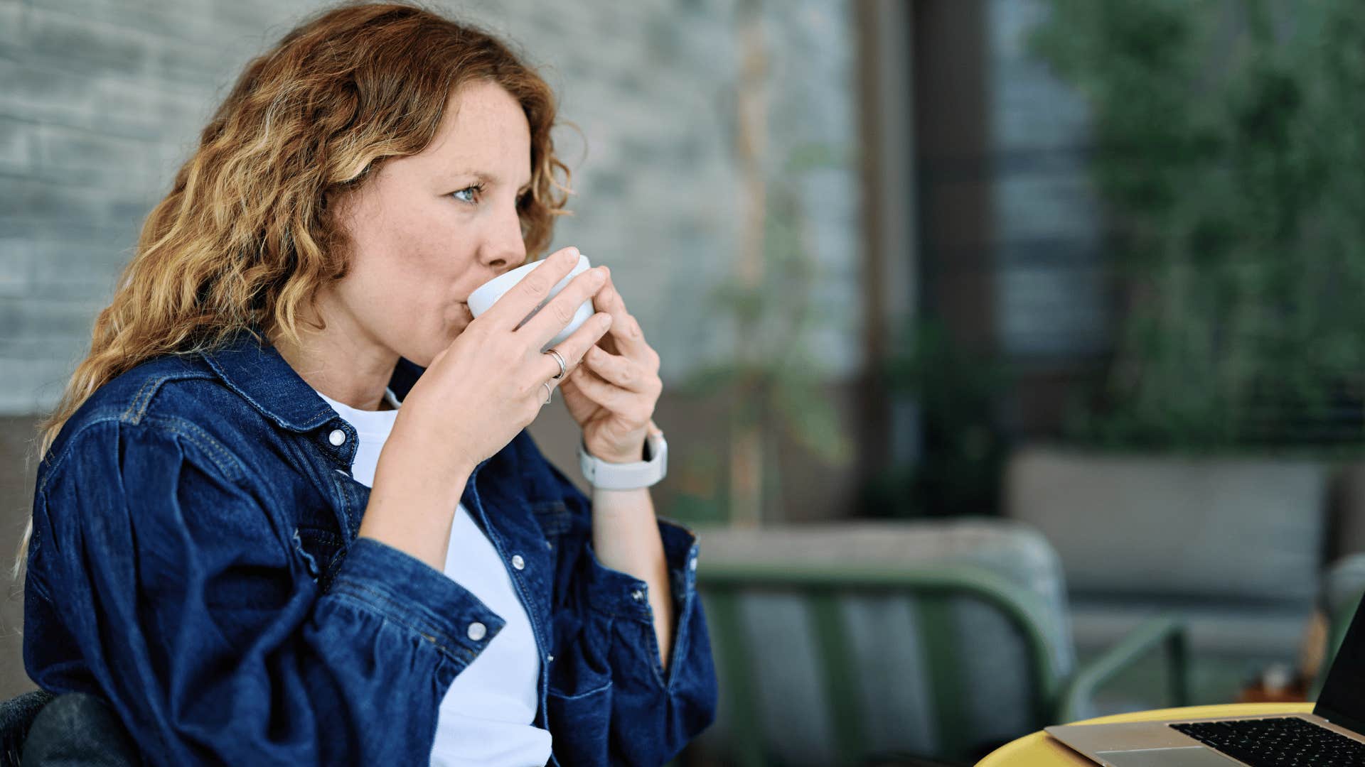 woman enjoying coffee as she loves to go on solo coffee shop trips