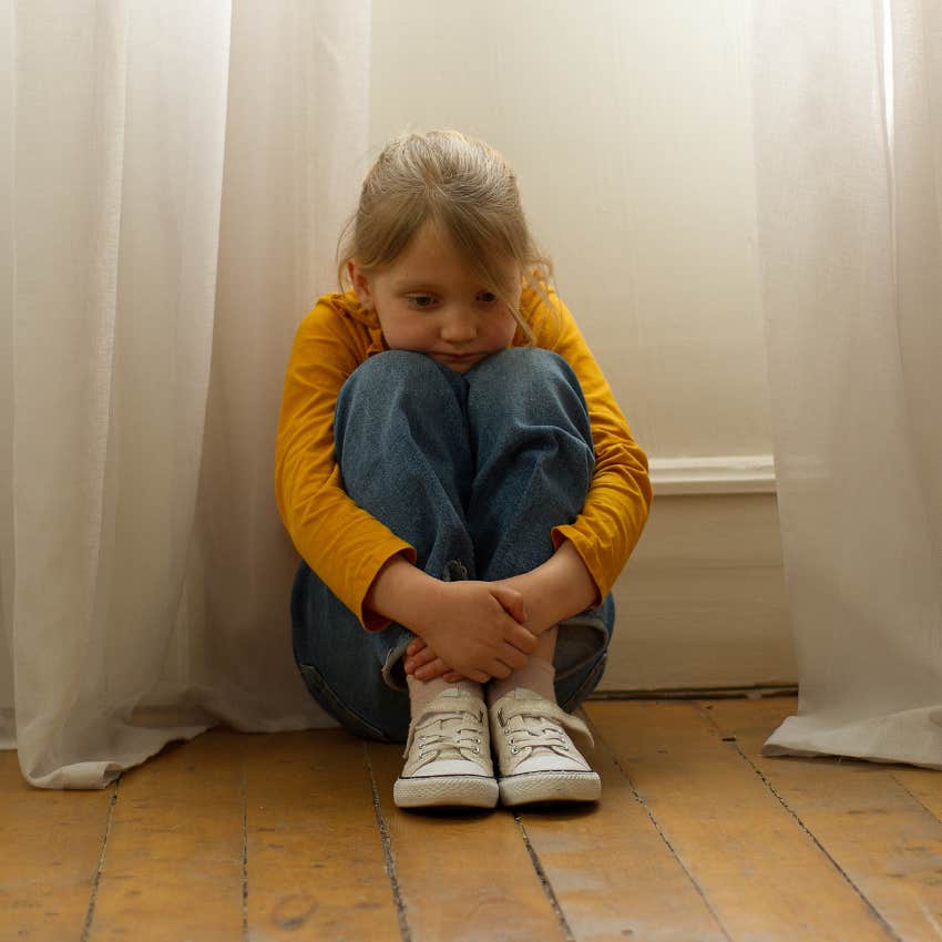 little girl hiding her emotions after learning they make others feel uncomfortable