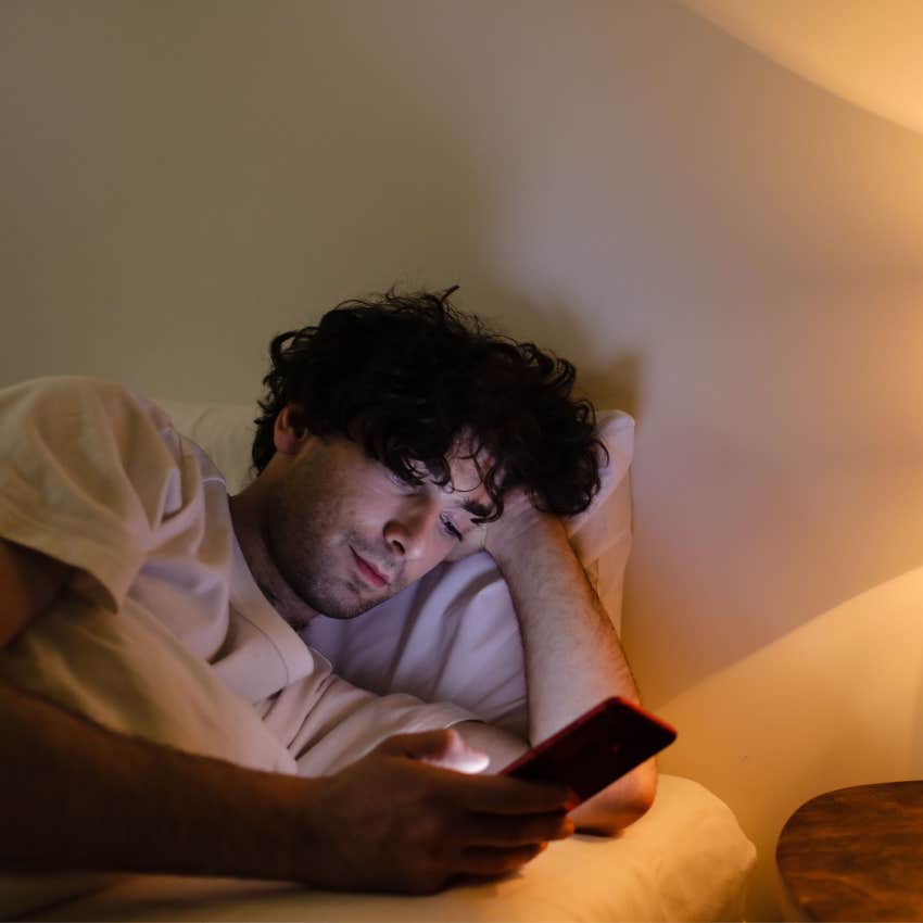 Person checking savings and investment balances late at night while still feeling anxious despite making financial progress