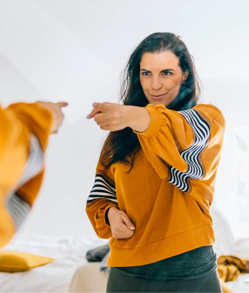 Woman who feels more productive being alone looking in the mirror 