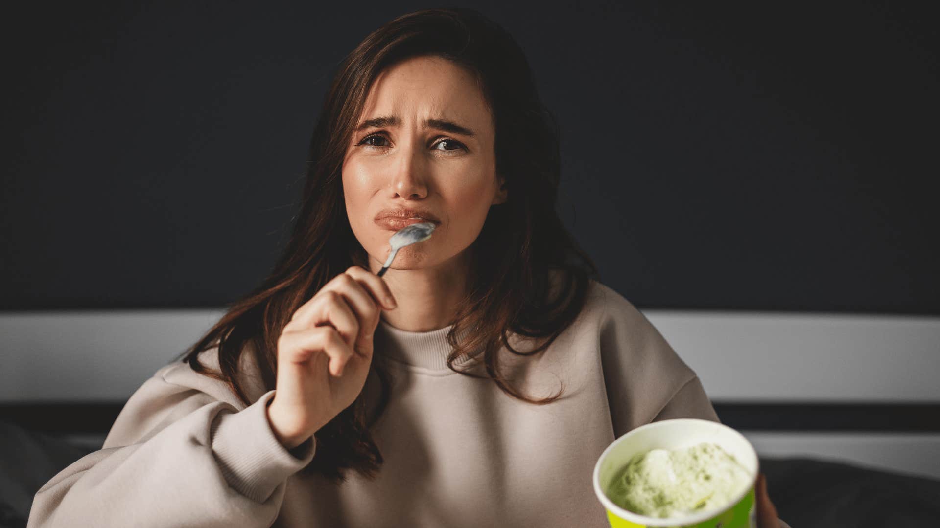 woman emotionally eating ice cream for comfort