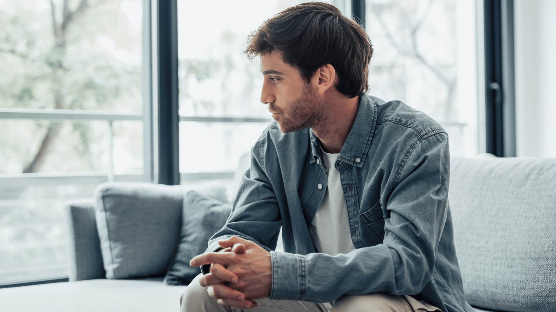 man on sofa looking deep in thought as he says give me some time to think about that