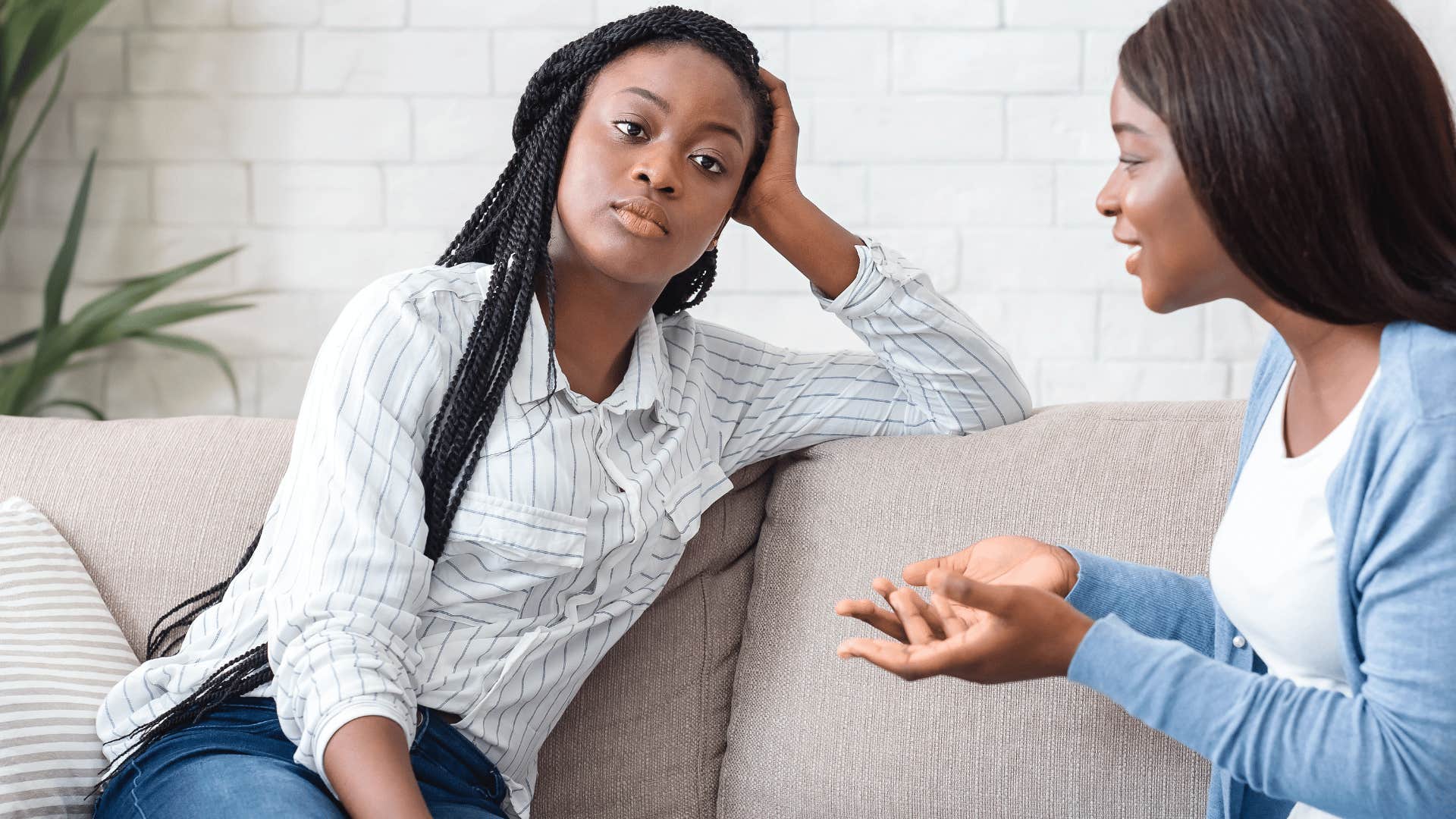 woman looking annoyed as friend keeps talking