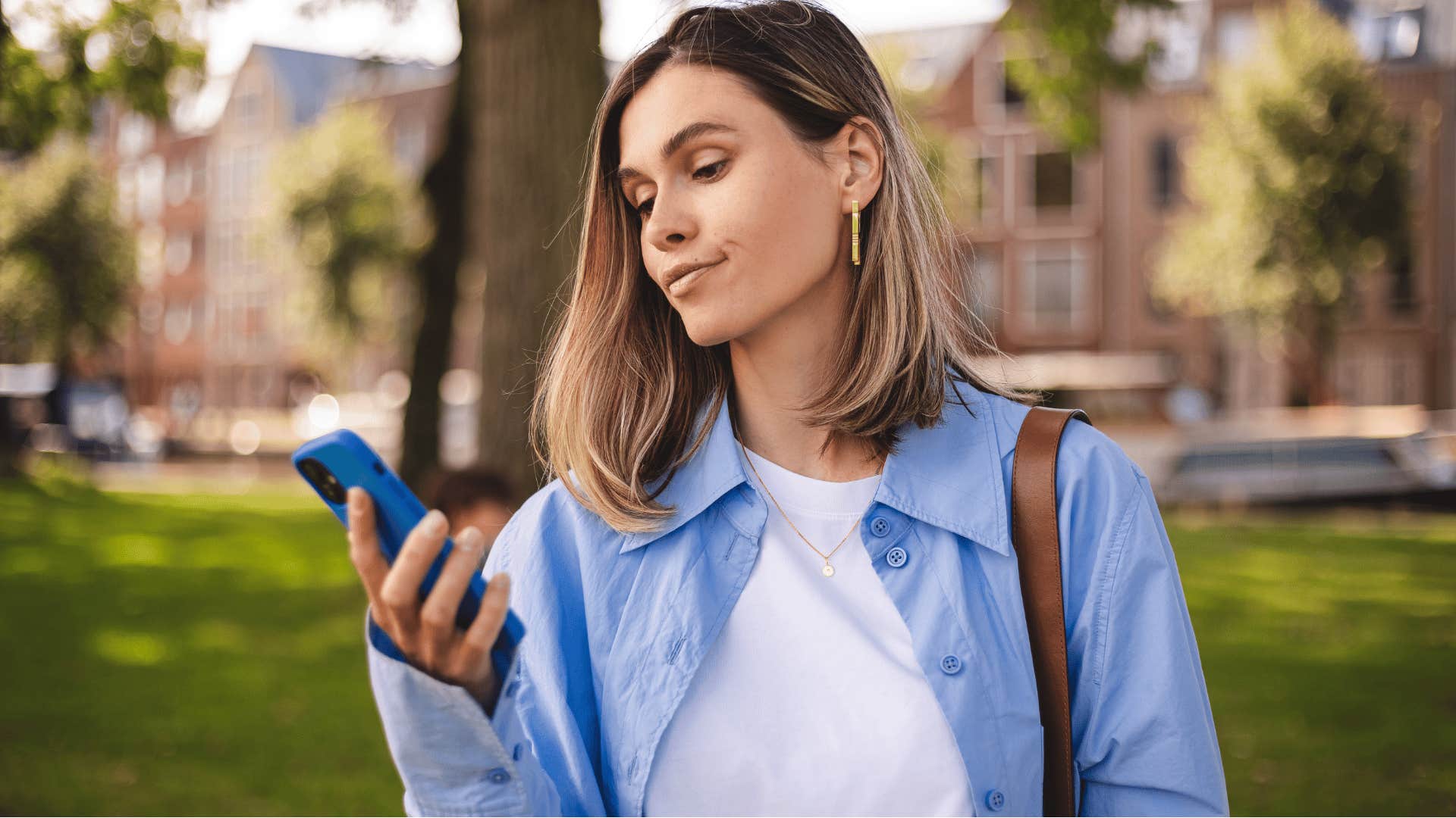 annoyed woman looking at phone saying here we go again