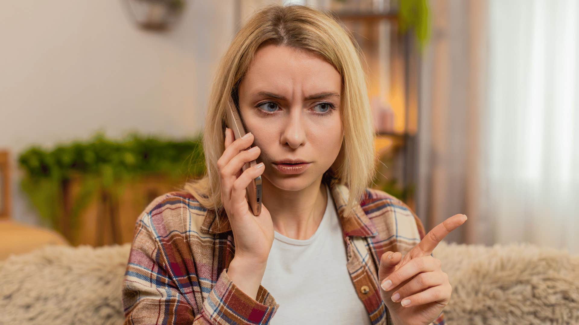 woman wagging her finger on the phone as she says you have one chance