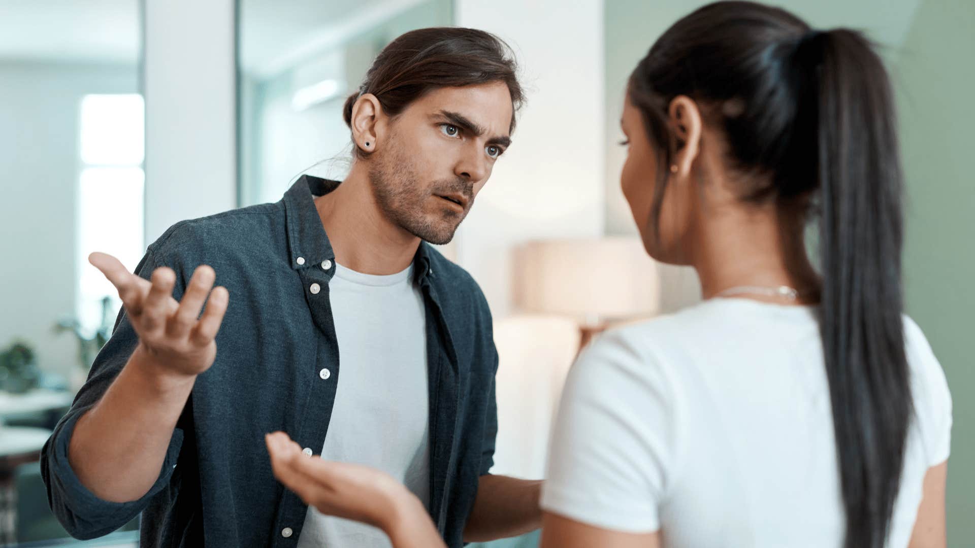 man arguing with woman as he says you tell me