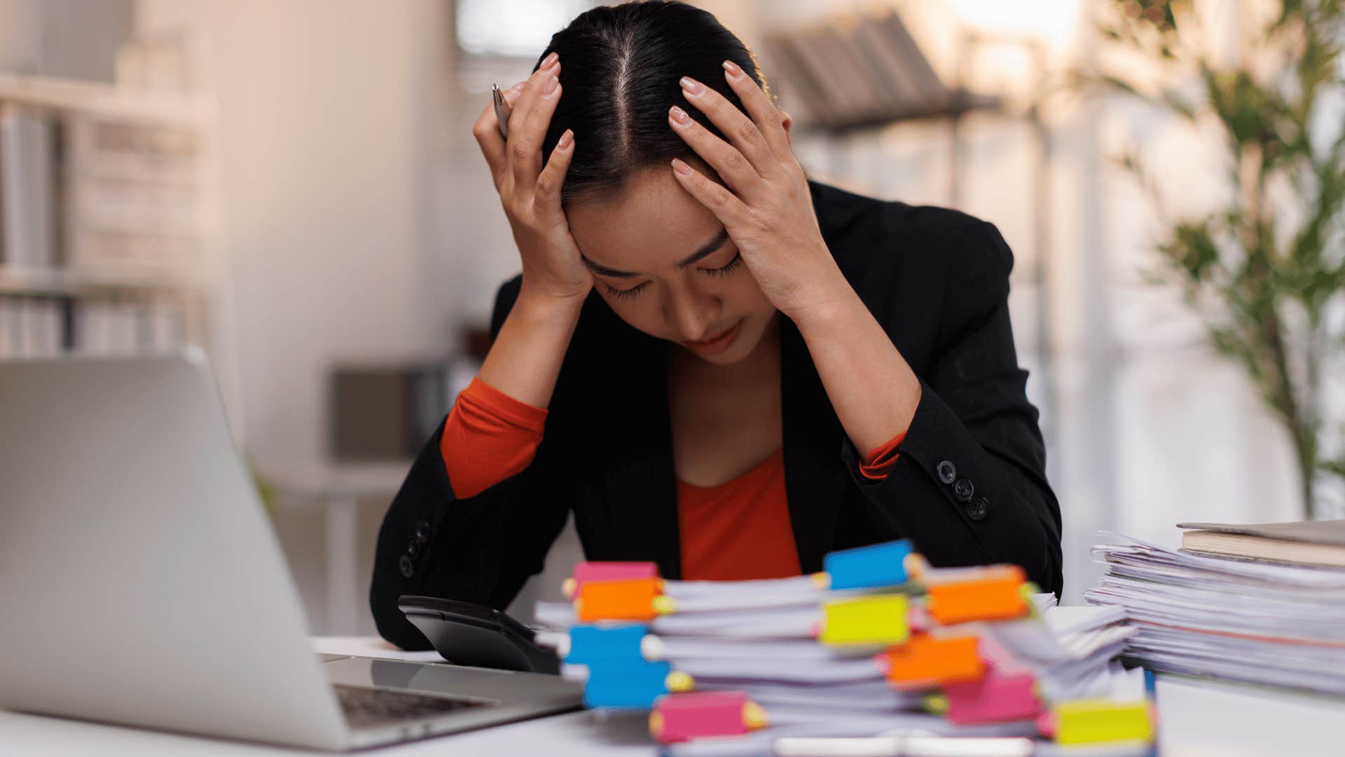 woman stressed at work as she says sorry i'm a bit of a mess today