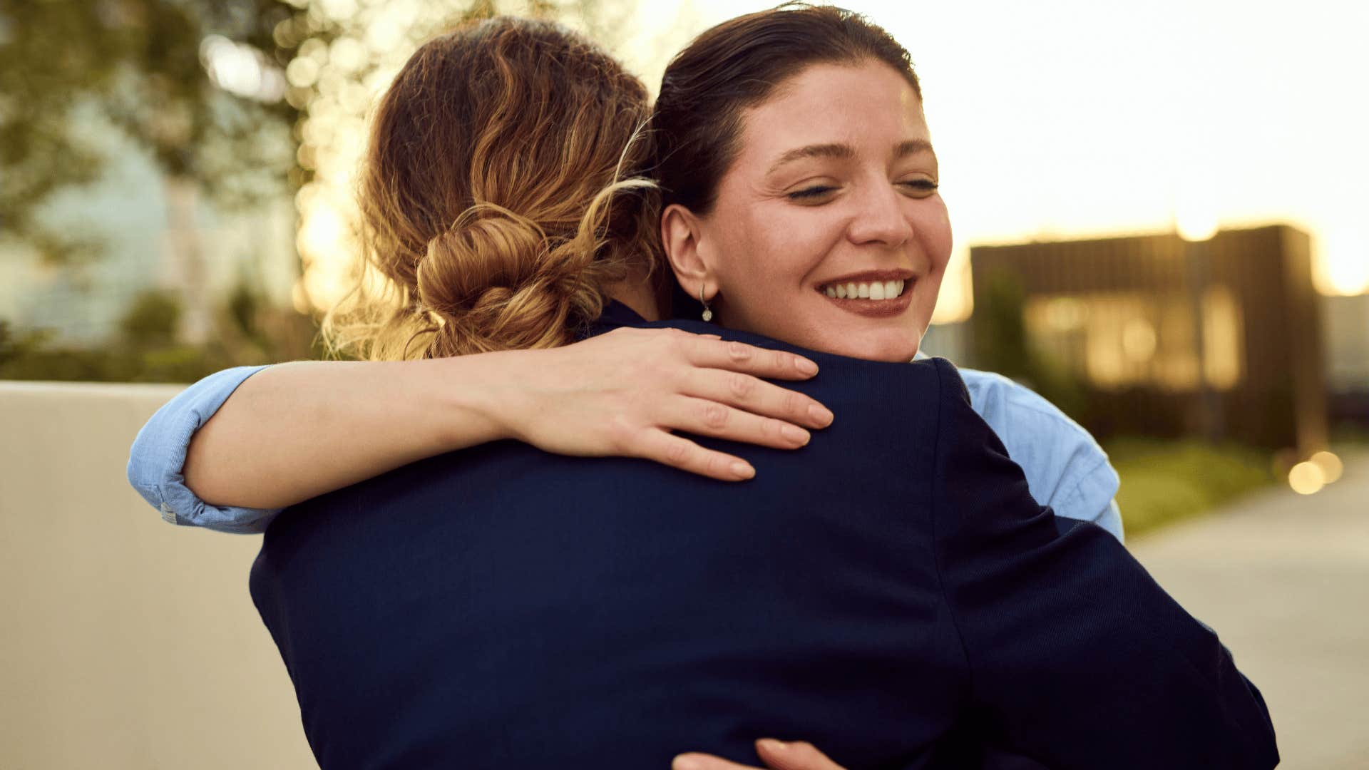 friends hugging one another as woman in light blue shirt says let's figure it out together