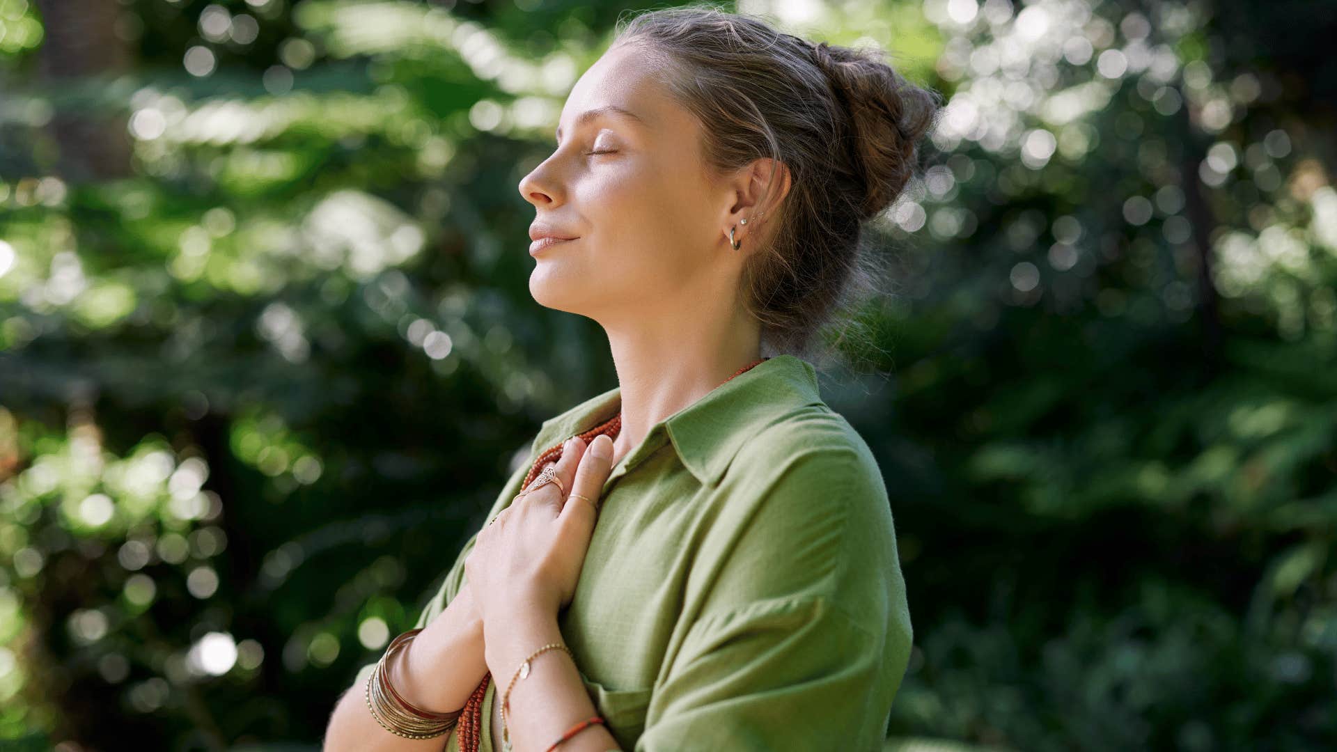 woman in green shirt meditating as she thinks one step at a time