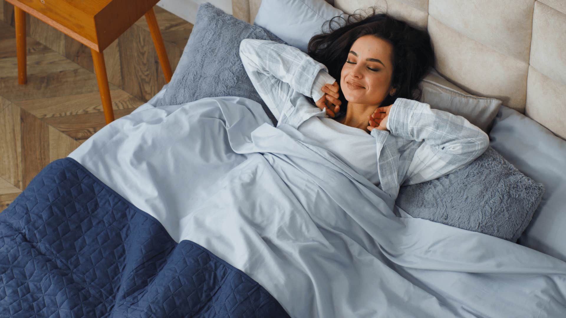 woman in bed relaxing and smiling as she understands that tomorrow is always a new day