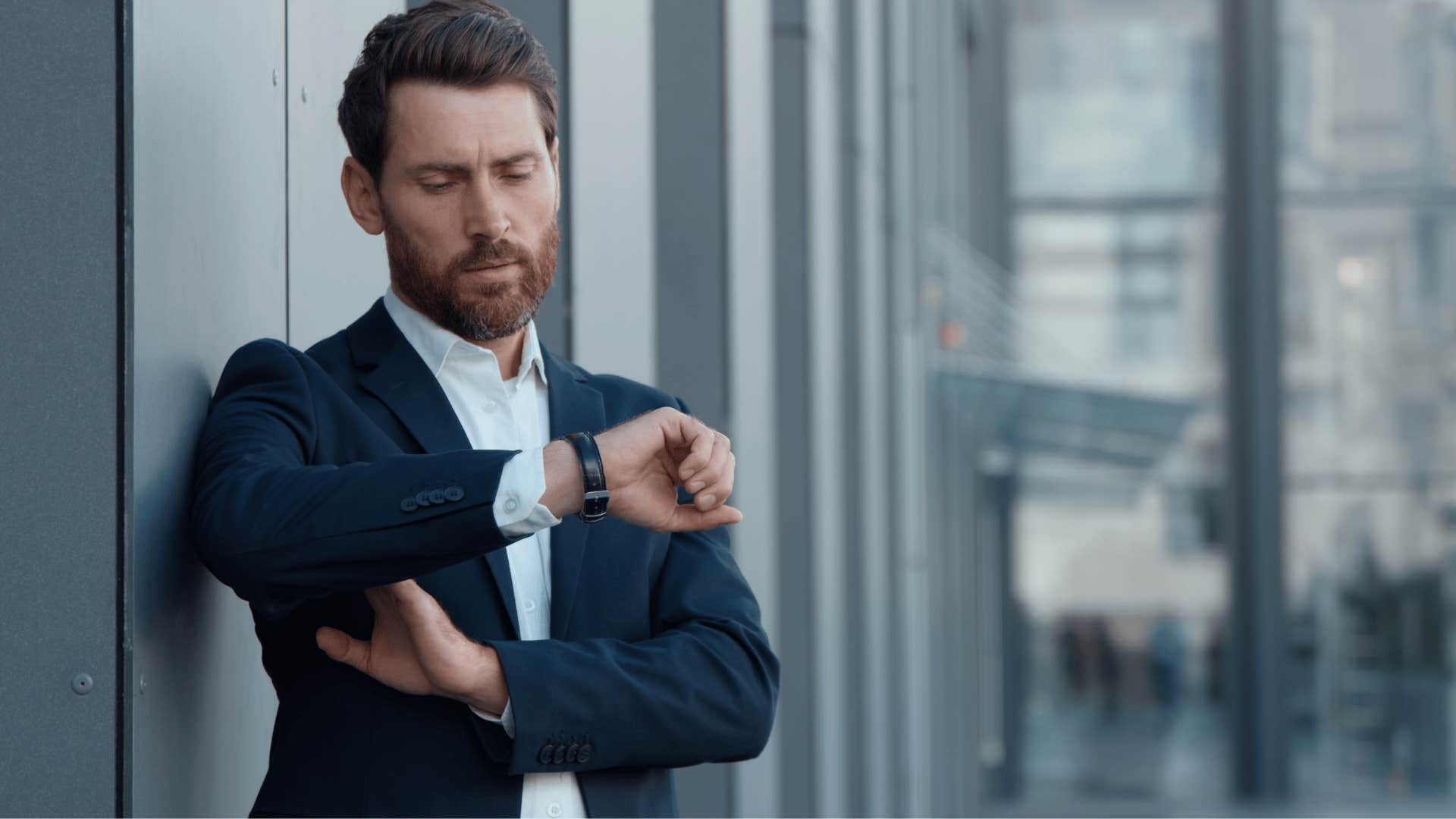 man in suit checking watch as he thinks i don't have time for this