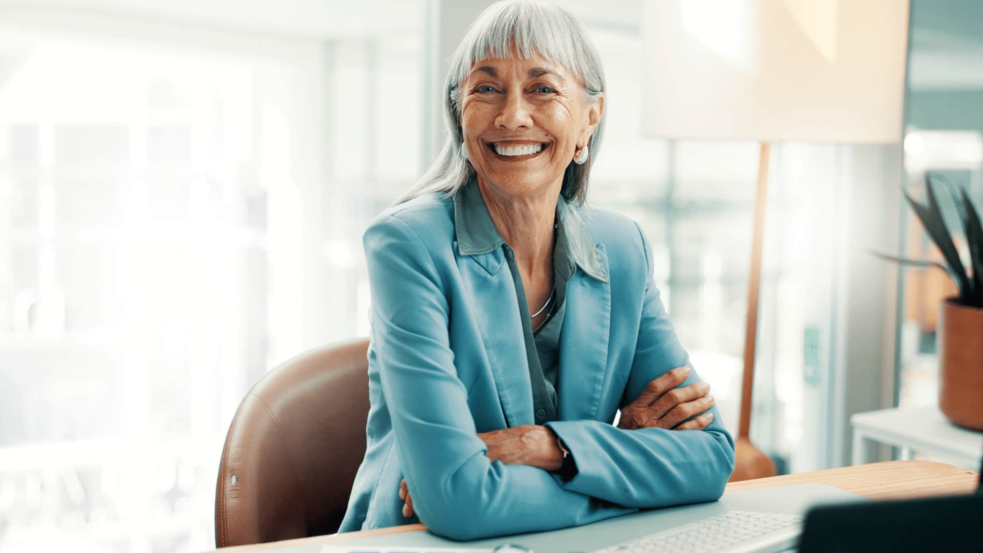 woman in light blue jacket smiling as she says i'll just wing it
