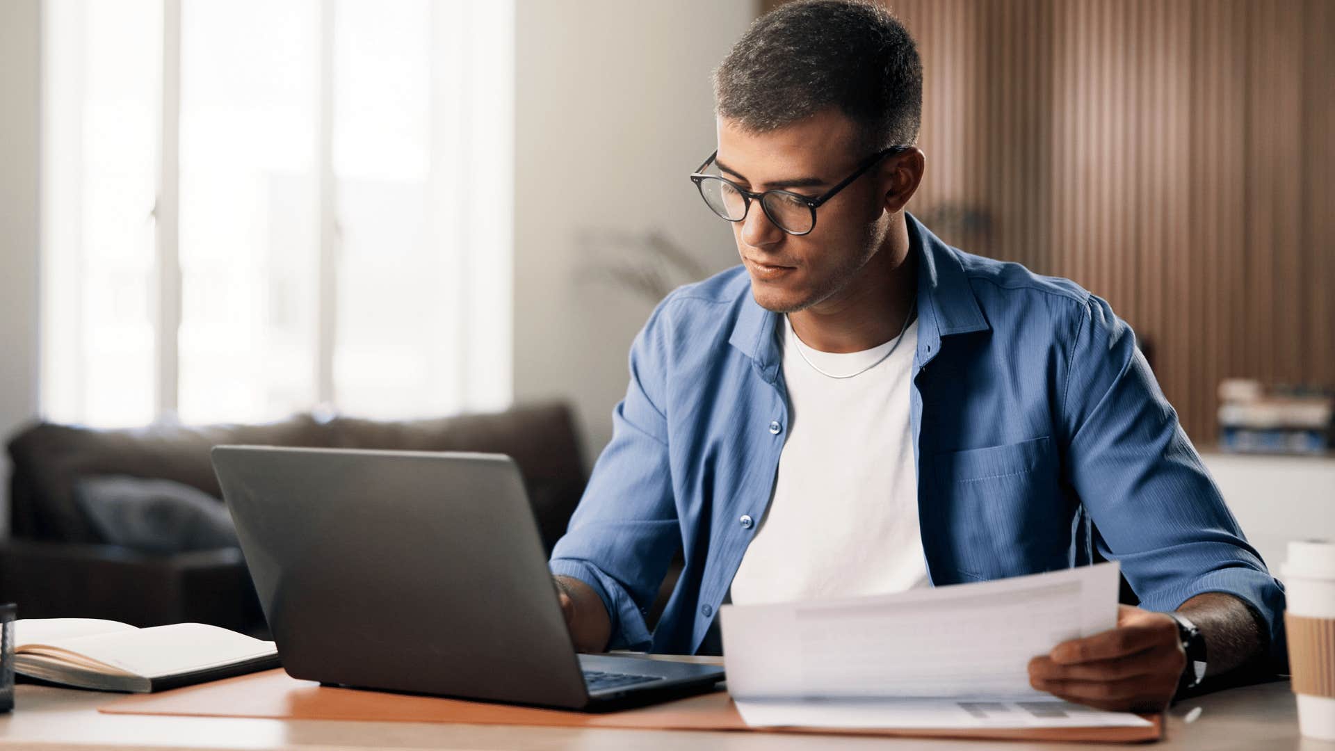 man is only following instructions as he works on laptop at desk