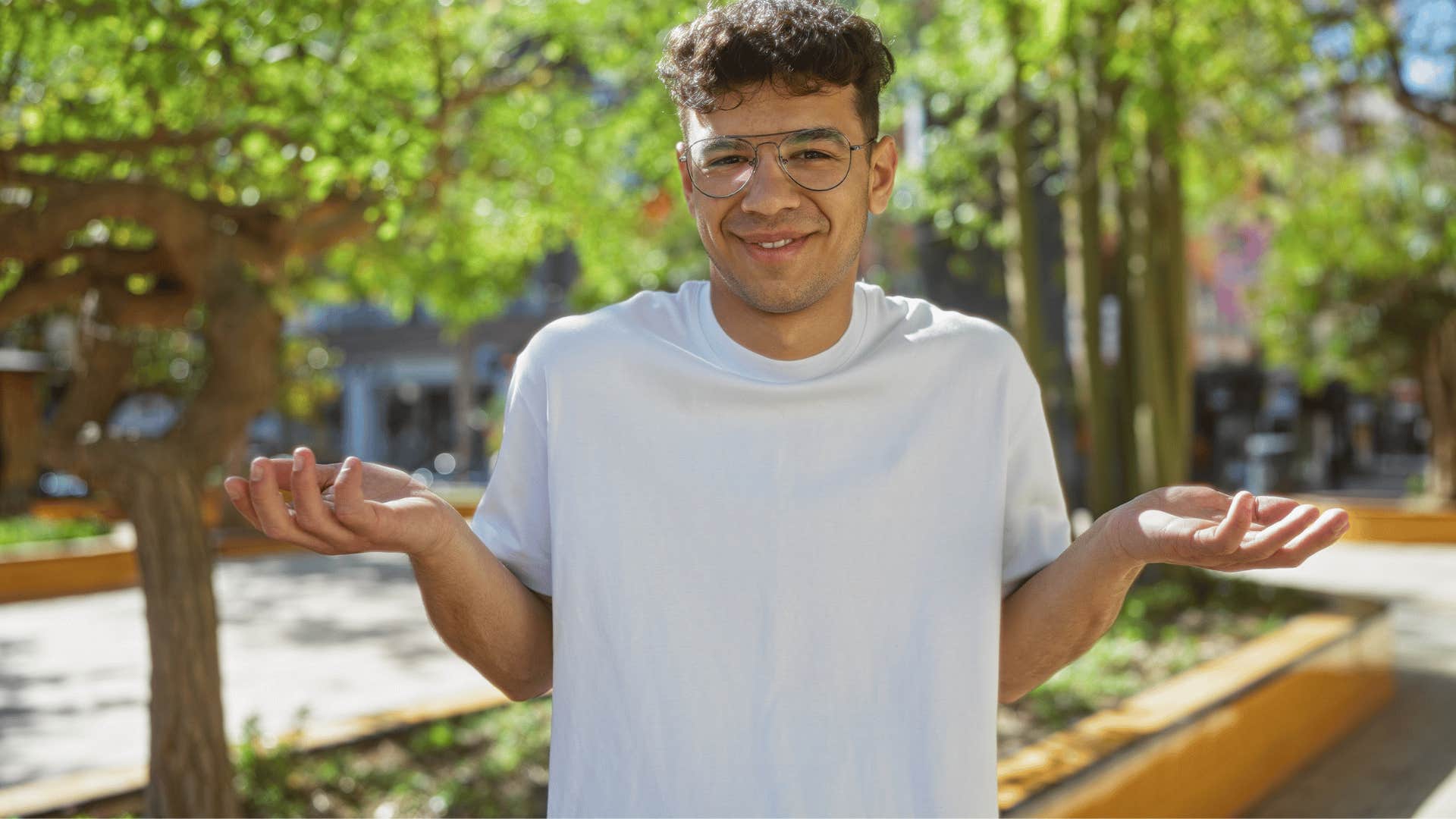 man in white shirt and glasses shrugging as he says well technically i wasn't wrong