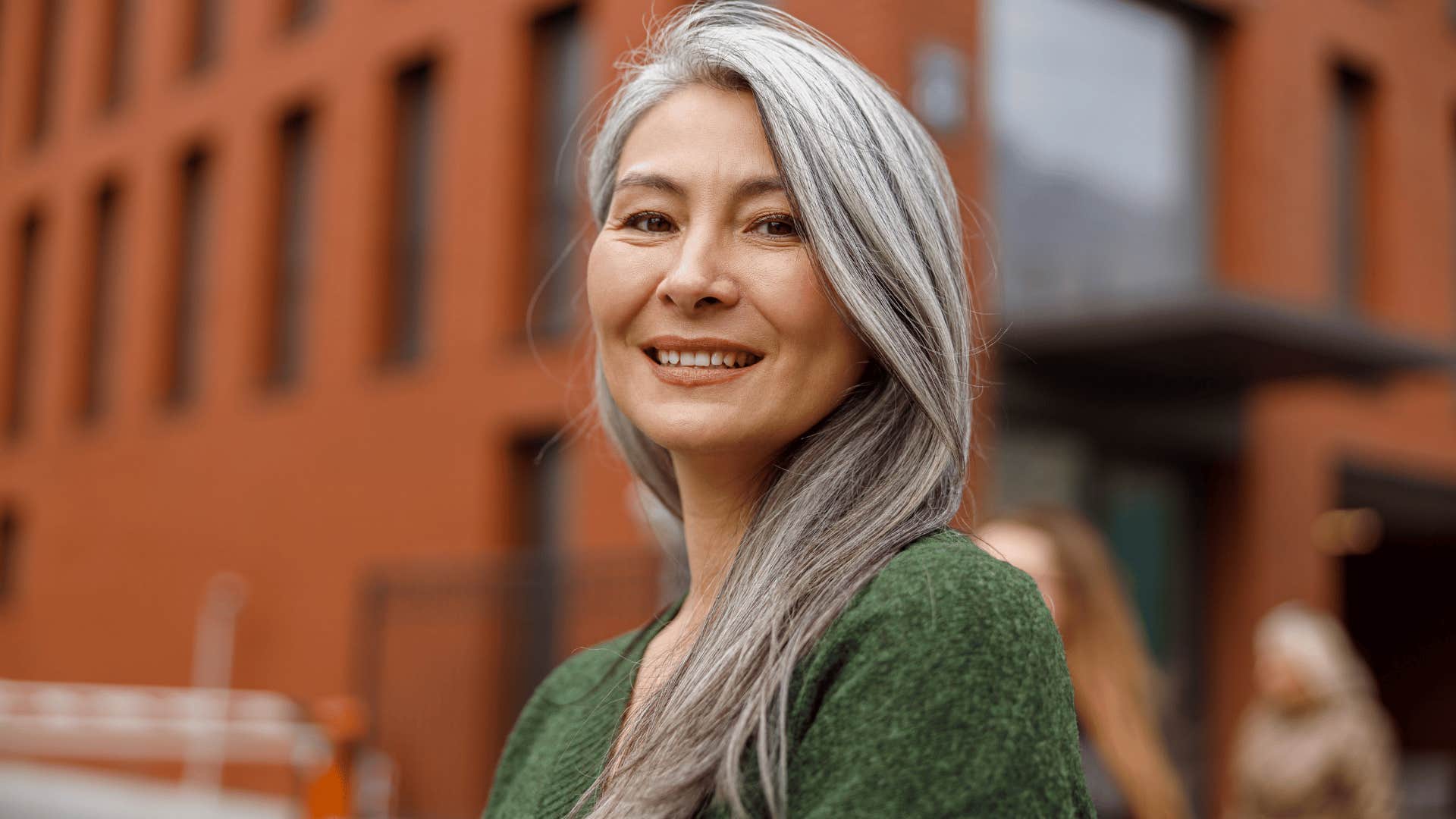 woman in green shirt staring at camera as she thinks it's okay i'll figure it out