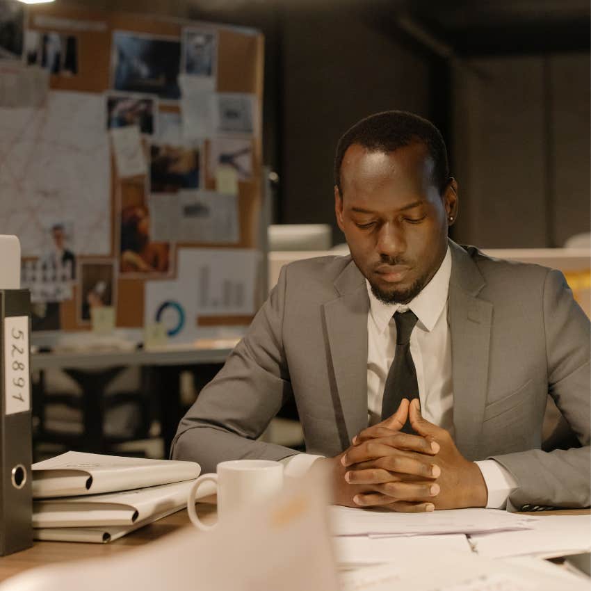 Calm man pausing to assess an urgent-looking work situation instead of immediately reacting with stress